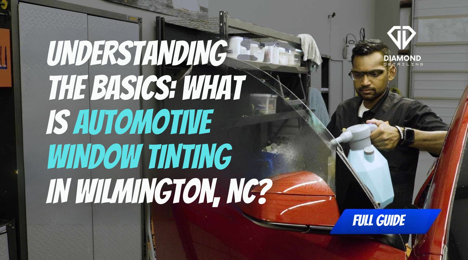 A Diamond Detailing technician in Troutman, NC sprays a red vehicle’s window with solution during the early stages of a professional installation, illustrating the process of What Is Automotive Window Tinting.