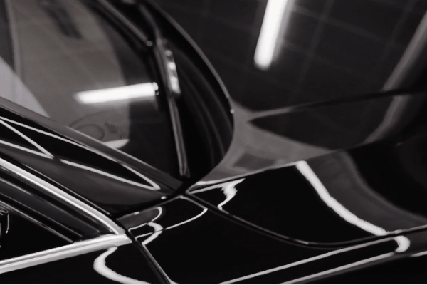 Close-up of a black vehicle with a deep glossy finish after professional auto detailing